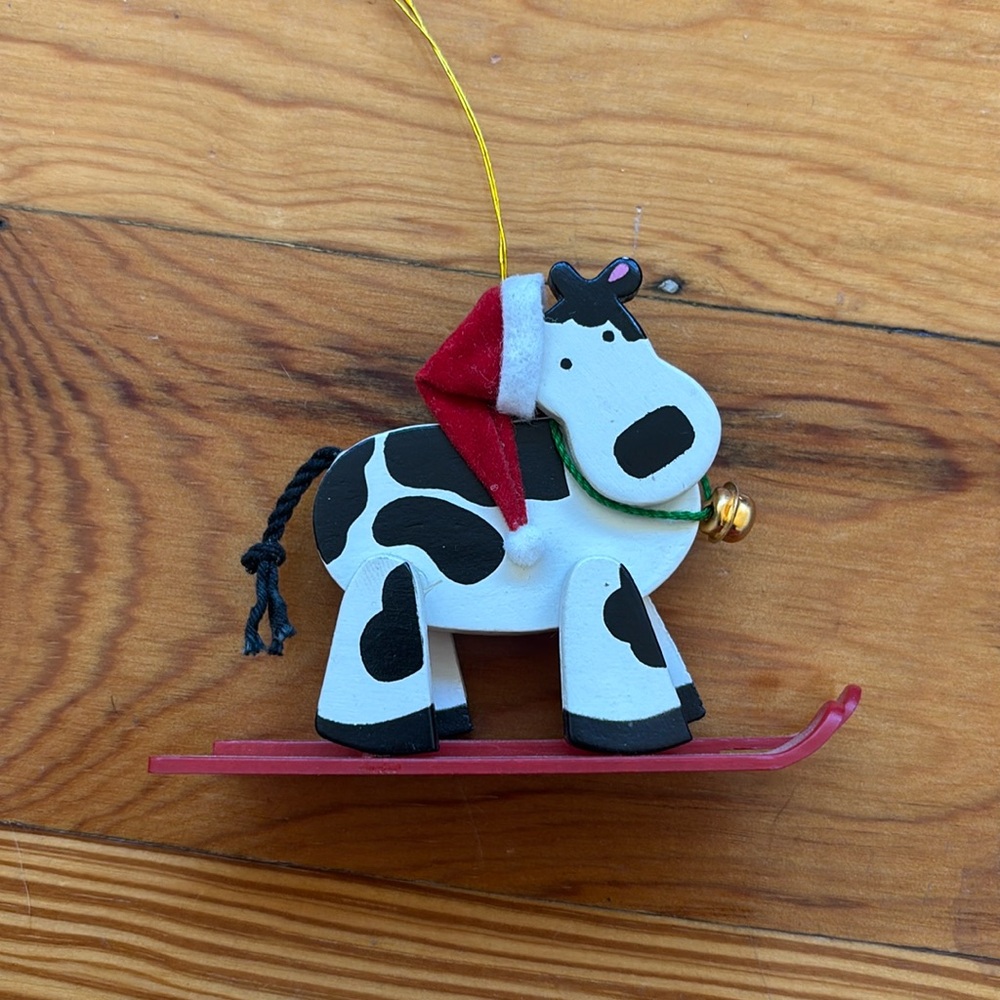 Avon cow on skis ornament